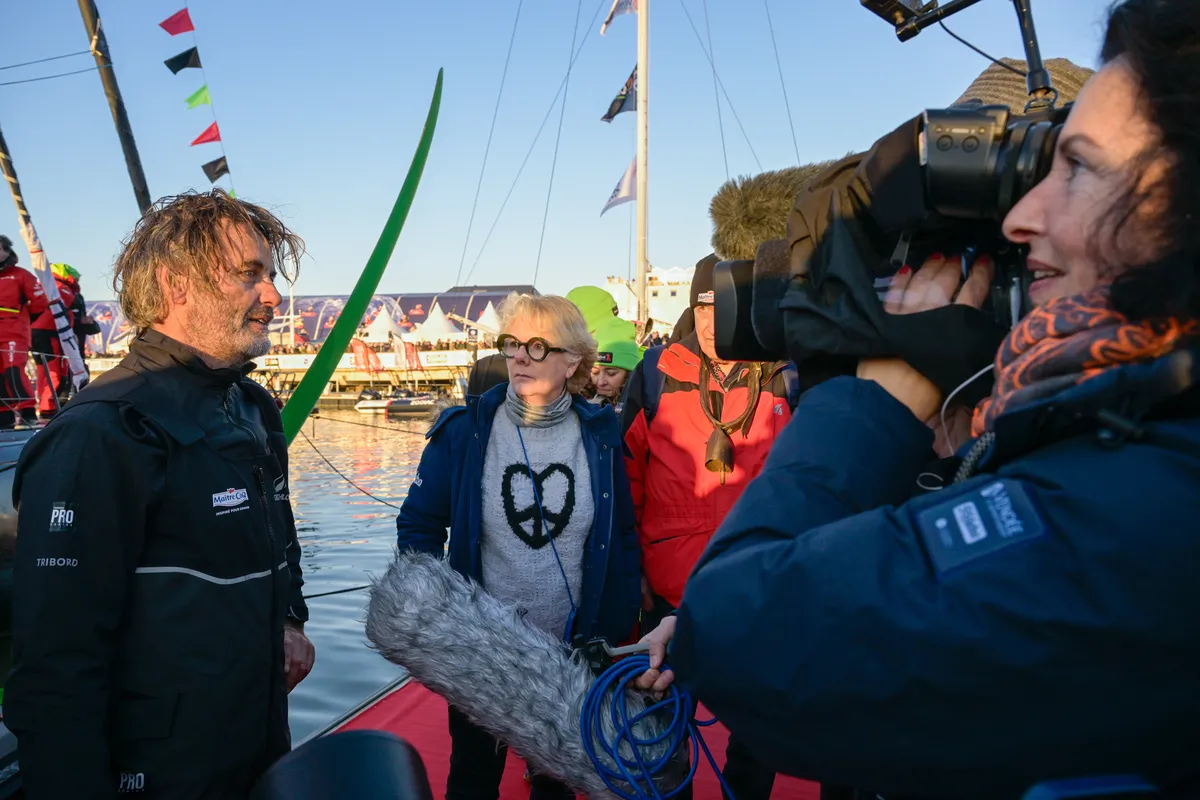 LES SABLES D’OLONNE, FRANCE - FEBRUARY 02, 2025 : Maître CoQ V skipper Yannick Bestaven (FRA) is being interviewed by media with Patricia Brochard (Sodebo President) arriving in Les Sables d'Olonne after retiring from the Vendee Globe, on February 02, 2025 - (Photo by Olivier Blanchet / Alea)