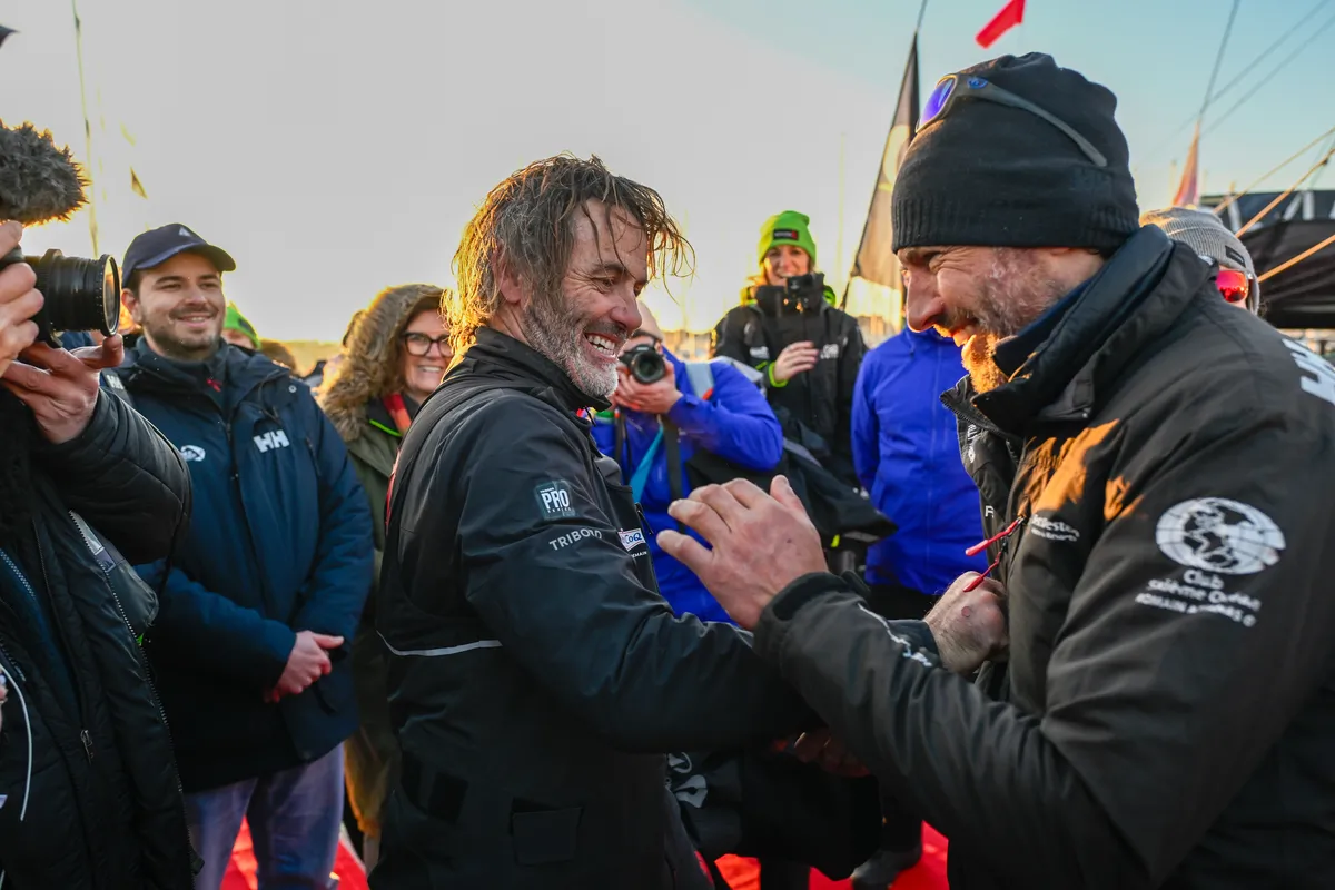 LES SABLES D’OLONNE, FRANCE - FEBRUARY 02, 2025 : Maître CoQ V skipper Yannick Bestaven (FRA) is congratulated by Fortinet - Best Western skipper Romain Attanasio (FRA) arriving in Les Sables d'Olonne after retiring from the Vendee Globe, on February 02, 2025 - (Photo by Jean-Louis Carli / Alea)